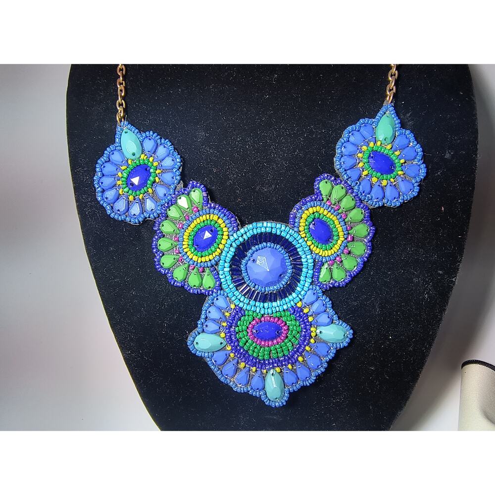 Gold plated chain necklace with blue, green and turquoise beaded fabric bib